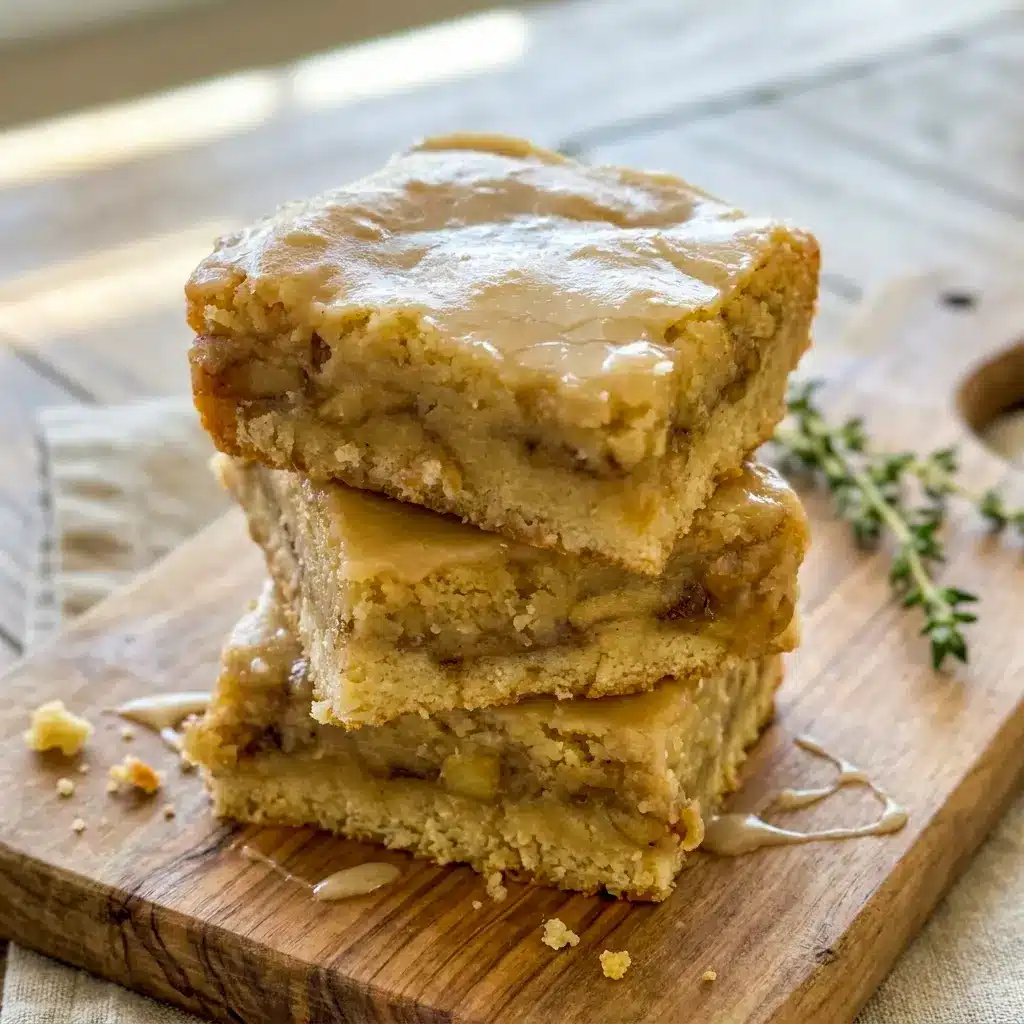 Close-up of a sliced Maple Glazed Apple Blondies bar showing chewy texture and cinnamon apples inside, perfect for Maple Apple Blondies Recipe inspiration.