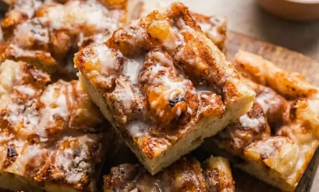 Cinnamon Roll Focaccia on a tray with a golden glaze, styled as one of the best Homemade Baked Snacks for brunch.