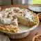 A slice of Pecan Cream Pie on a holiday plate, styled as Pies With Pecan Crust for a festive Thanksgiving dessert.