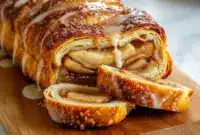 A golden, flaky Apple Kringle pastry with spiced apple filling and vanilla glaze, perfect for Fall Snacks And Desserts or cozy weekend Breads And Pastries.