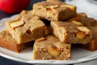 Apple Spice Bars – The Sweet, Comforting Dessert for Winter You Need1 A stack of soft, golden Apple Spice Bars filled with cinnamon apples, perfect Desserts For Winter and cozy Homemade Apple Blondies vibes.