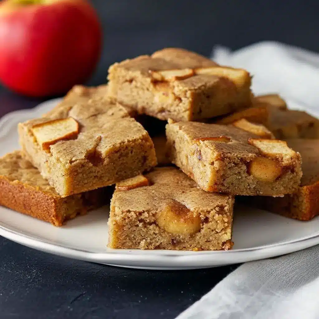 Apple Spice Bars – The Sweet, Comforting Dessert for Winter You Need1 A stack of soft, golden Apple Spice Bars filled with cinnamon apples, perfect Desserts For Winter and cozy Homemade Apple Blondies vibes.