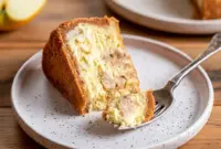 Close-up slice of apple cider cheesecake with graham cracker crust and cinnamon-sugar finish, a decadent treat reminiscent of Apple Cider Brownies, worthy of the Best Cinnamon Desserts list and perfect for Fall Cookout Desserts.