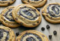 Close-up shot of freshly baked Chocolate Chip Brownie Swirl Cookies showing their rich, fudgy centers and golden cookie edges — a mouthwatering batch of Brookie Cookies perfect for dessert lovers.