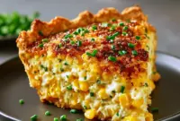 Cheddar Sweet Corn Pie — The Ultimate Corn Pie for Weeknights Golden-brown Corn Pie topped with melted cheddar, served warm as a comforting Savory Pie made with Sweet Corn, perfect for weeknight Veggie Dishes or Vegetable Sides.