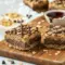 Close-up of chewy Chocolate Oatmeal Cookie Bars layered with peanut butter and melted chocolate, the perfect Dessert Using Oatmeal for quick and easy no-bake treats.