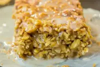 Cinnamon Roll Baked Oatmeal — A Cozy Cinnamon Roll Bake For Chilly Mornings Close-up of golden-baked cinnamon-swirl oatmeal squares with a light glaze — a comforting Cinnamon Roll Bake that's also ideal for Dairy Free Breakfasts, listed under top Baked Oatmeal Recipes, pairs well with Tofu Scramble, and works as a Gluten Free Sugar Free option for Free Snacks, simple Gluten Free Breakfasts, and everyday Oatmeal Recipes.