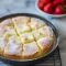 Classic French Butter Cake — Best Butter Cake Recipe for a Decadent Dessert Golden, buttery square cake with a crackly sugar top on a white plate, garnished with powdered sugar and fresh berries.