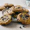 Fall Easy Dessert Recipes — Chewy Pumpkin Chocolate Chip Cookies Close-up of chewy pumpkin chocolate chip cookies with melted chocolate pockets and warm spice flecks on a cooling rack.