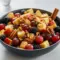 Fall Fruits Salad with Orange Cinnamon Dressing — Cozy, Spiced And Simple Overhead bowl of fall fruit salad with apple cubes, red grapes, blackberries and pecans, glazed in an orange-cinnamon dressing.