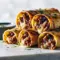 French Dip Roll Ups Tortilla — Perfect Quick Weeknight Meal Golden-baked Roll Ups Tortilla stuffed with melty cheese and Sliced Roast Beef, served with a bowl of au jus for French Dip dipping, garnished with crispy French Fried Onions and showcasing juicy Tender Roast Beef in portable Tortilla Rolls — a savory French Dip Sandwich riff and perfect Roll Ups for Quick Weeknight Meals.