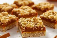 Irresistibly Soft Pumpkin Oatmeal Bars You’ll Want All Fall Long2 Close-up of golden Easy Pumpkin Oatmeal Bars with a creamy pumpkin center and crumbly oat topping — the ultimate cozy fall treat from a simple Pumpkin Oatmeal Bar Recipe.