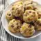 Loaded Breakfast Biscuits - Make Ahead Camping Food Breakfast Golden Breakfast Biscuits filled with eggs, bacon, and cheese on a rustic campfire table — the perfect Make Ahead Camping Food Breakfast for easy Campfire Cooking Breakfast outdoors.