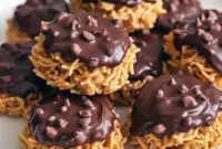 Must-Try Christmas Baking Idea Chocolate Peanut Butter Haystacks Close-up of chocolate peanut butter haystacks on parchment — perfect for Christmas Baking and a festive Dessert Platter, a crowd-pleasing Candy Recipes Homemade choice that ends any Snack Attack; think classic Cookies Recette vibes with Butterscotch Chips and crunchy Chocolate Peanuts for an irresistible Sweet And Salty finish — an easy addition to Easy Snack Recipes collections.