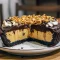 Peanut Butter Pie with Oreo Crust — Ultimate No-Bake Treat Close-up of a no-bake peanut butter pie with glossy chocolate ganache, Oreo crust, and crushed candy and peanuts on top.
