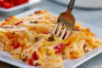 Pimento Cheese Hash Brown Casserole — Southern Hashbrown Recipes for Brunch Close-up of a golden, bubbling pimento cheese hash brown casserole in a baking dish, topped with chopped green onions — a comforting Potato Dishes favorite that pairs well with salads for Veggie Dishes, works great as crowd-pleasing Side Recipes, and nods to classic Southern Recipes.