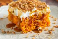 A slice of Pumpkin Better Than Sex Cake topped with whipped cream, caramel drizzle, and toffee bits — a dreamy Pumpkin Dessert perfect for cozy Fall Dessert Recipes and lovers of rich Yummy Sweets.