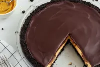 Skrewball Pie — Salted Chocolate Peanut Butter Pie with a Boozy Twist Slice of Skrewball pie with Oreo crust, whipped peanut butter filling and shiny chocolate ganache, garnished with chopped peanuts and flaky salt.