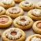 Thanksgiving Quick Desserts Pumpkin Pie Cookies for Busy Hosts Large pumpkin pie–style cookies with caramelized bottoms and a creamy pumpkin center, plated with whipped cream and cinnamon sticks — styled as Pumpkin Pie With Cookie Crust inspired bites, shown alongside other Seasonal Cookies, finished with pretty Pumpkin Pie Cookie Toppings for Aesthetic Fall Desserts.