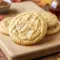 Close-up of Chewy Maple Brown Sugar Cookies topped with maple glaze on a rustic plate, showcasing golden edges and a soft, chewy texture perfect for Maple Desserts and fall baking.