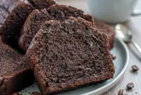Decadent Mocha Bread – A Rich Dark Chocolate Breakfast Treat You’ll Crave1 Close-up of a sliced Dark Brown Bread Loaf, rich with chocolate chips and a dark mocha center—looks like a decadent Breakfast Chocolate treat made from Homemade Bread With Cocoa.