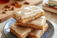 Delicious Soft Maple Donut Bars – A Power-Packed Baked Breakfast to Love1 Soft, fluffy Maple Donut Bars drizzled with a sweet glaze, styled as a cozy Baked Breakfast and simple Sweet Treat made from easy Breakfast Baked Goods, perfect for fans of Breakfast Donuts, classic Maple Recipes, and nostalgic Maple Bars—a warm, homemade option for anyone looking for delicious Things To Bake.