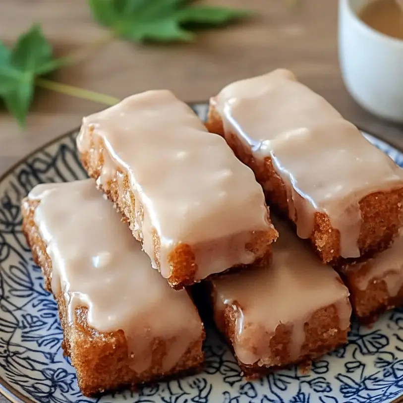 Soft, fluffy Maple Donut Bars drizzled with a sweet glaze, styled as a cozy Baked Breakfast and simple Sweet Treat made from easy Breakfast Baked Goods, perfect for fans of Breakfast Donuts, classic Maple Recipes, and nostalgic Maple Bars—a warm, homemade option for anyone looking for delicious Things To Bake.