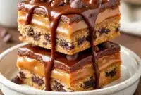 Good Bar Recipes – Try These Easy Caramel Cookie Bars for Dessert Tonight1 Close-up of gooey Caramel Cookie Bars with a golden crumbly top and melted caramel center, perfect for Good Bar Recipes and Easy Desserts With Caramel, styled as cozy Fall Bar Cookie Recipes on a rustic wooden plate.