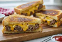 Irresistible Grilled Patty Melt – Ultimate Fun Grilled Cheese With Meat1 Close-up of a crispy grilled patty melt sandwich with melted cheese and juicy beef layered between golden toasted bread, served hot and sliced in half on a rustic plate.