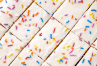 Irresistible Pop Tart Cookie Bars – Eat Dessert First with These Powerful Sweets Treats2 Golden Pop Tart cookie bars stacked with colorful frosting drizzle and sprinkles, styled as an irresistible dessert centerpiece.