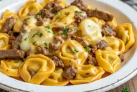 One-Pan Beef Dishes Magic Cheesesteak Tortellini in Creamy Provolone2 A one-pan creamy cheesesteak pasta skillet featuring Tortellini Recipes cooked Al Dente with sliced beef, peppers, and melted Provolone. A rich, cozy option for Pasta Dinners, Beef Dishes, Beef Casserole Recipes, and Pasta Dinner Recipes, perfect as an easy Main Dish Recipes idea with golden, cheesy tortellini close-up.