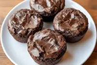 Close-up photo of High Protein Brownie Bites in a mini muffin pan, rich and chocolatey with a soft, fudgy center, showing a healthy bite-sized treat perfect for snacking.