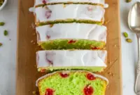 Sweet & Dreamy Pistachio Bread With Maraschino Cherries – Pure Holiday Bliss2 Moist pistachio loaf studded with maraschino cherries, drizzled in glossy almond glaze and styled for a warm holiday dessert table.