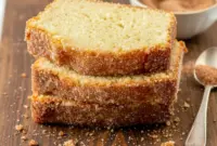 Soft, golden cinnamon sugar donut loaf sliced on a board, showcasing a tender crumb and warm spice—perfect Cinnamon Sugar Donut Sweet Bread Recipe style.