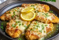 Crispy Lemon Chicken Romano on a plate with golden crust, fresh parsley, and lemon slices — a bright, flavorful twist on classic poultry and lemon chicken recipes.