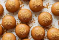 Delicious Biscoff Cheesecake Protein Balls – A Trim Healthy Indulgence Treat1 A close-up of creamy Cheesecake Protein Balls made with rich cookie butter, styled as bite-sized Biscoff Protein Balls on a plate, showcasing delicious Biscoff Balls with a smooth texture. These no-bake treats double as easy Food Ball snacks, inspired by classic Biscoff Snacks and sweet Butterscotch Protein Balls flavors.