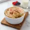 A single-serving baked oats dish flavored like a sugar cookie, golden on top and served in a small ramekin, showing a cozy, high-protein breakfast option.