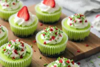 Delightful Grinch Mini Cheesecakes – A Festive Grinch Food Idea for the Holidays2 Bright green mini Grinch cheesecakes topped with whipped cream and sprinkles, displayed as fun Christmas bites perfect for parties, potlucks, and kid-friendly holiday treats.