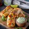 Crispy homemade eggrolls filled with chicken, veggies, and cheese served with dipping sauce; the perfect Southwest Eggrolls Recipe for parties and delicious Appetizer Snacks.
