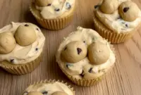 A close-up of creamy yogurt cups layered with cookie dough bites, showing Protein Cookie Baking Ideas, Healthy Protein Cookie Dough, Protein Cookie Dough For One, How To Make Protein Cookie Dough, How To Make Protein Cookie Dough Bites, Cookie Dough Yogurt, Healthy Protein Desserts, High Protein Yogurt, and Protein Baking in a delicious no-bake treat.