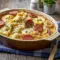 Creamy slow cooker pierogi casserole with sliced kielbasa sausage, melted cheese, and rich sauce served hot as a comforting family-style dinner.