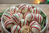 Irresistible Little Debbie Christmas Tree Cake Truffles – Must-Have Christmas Desserts1 Close-up of creamy Christmas Tree Truffles made from Little Debbie Christmas Snack Cakes, dipped in white chocolate with red drizzle and green sprinkles, displayed as festive Christmas Bakery Desserts for easy Desserts Holiday celebrations.