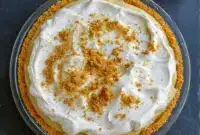 Luscious Bourbon Banana Cream Pie Recipe Inspiration with a Bold Bourbon Twist1 A luscious bourbon banana cream pie topped with fluffy whipped cream and cookie crumbs, showcasing rich banana layers and a boozy twist—perfect for fans of Dinner Desserts, Banana Cream Pie Flavor, Bourbon Cream Pie, Banana Whiskey Pie Recipe, Pie Recipe With Bourbon, Banana Cream Pie Recipe Inspiration, Banana Bourbon Pie, Bourbon And Pie, and Bananas Foster Cream Pie.