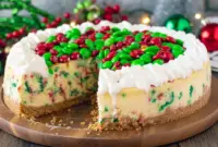 A beautifully decorated Christmas Decorated Cheesecake topped with festive sprinkles and holiday accents, styled as an Easy Homemade Christmas Cheesecake inspired by Christmas Tree Snack Cake Cheesecake designs. This cozy dessert showcases How To Make Festive Cheesecake at home with a cheerful Christmas Theme Cheesecake look, perfect for fans of Easy Christmas Cheesecake, classic Christmas Cheesecake Recipes, a joyful Holiday Cheesecake, and a stunning Christmas Cheesecake centerpiece.