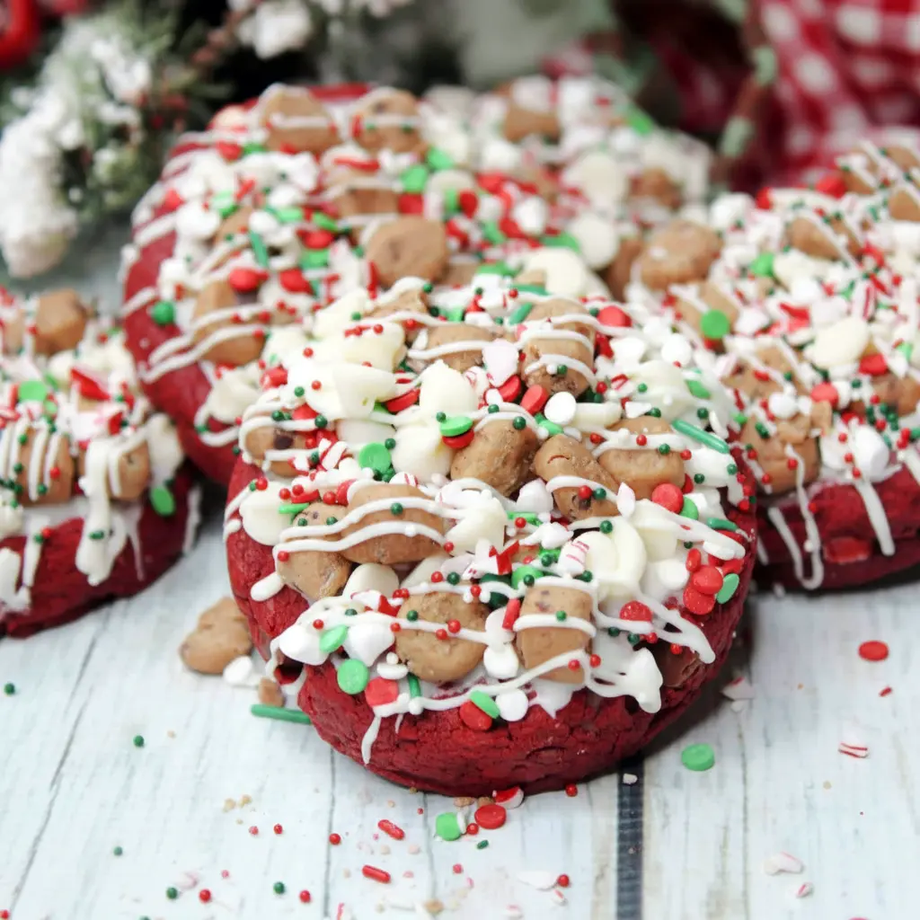 Bright red velvet Santa’s cookies loaded with chocolate chips, mini marshmallows, icing, and crushed candy canes—festive Christmas Cookies Gourmet style treats perfect for holiday baking, Fun Christmas Cookie Ideas, and Unique Christmas Cookies Recipes, ideal for gifting, snacking, and Bake Sale Treats.