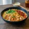 Spicy creamy ramen bowl featuring tender chicken, garlic sauce, and fresh greens, inspired by Chicken Birria Ramen, Chicken Fried Ramen Noodles, and classic Ramen Chicken Noodle Recipes, topped with creative Ramen Topping Ideas, perfect for fans of Ramen Crockpot Recipes and bold noodle dishes.