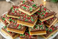 Unbelievably Good Saltine Toffee Christmas Crack for Gorgeous Christmas Dessert Table1 A glossy sheet of chocolate-covered Saltine Toffee topped with Toasted Almonds, broken into pieces and arranged on a holiday Dessert Tray, surrounded by festive Christmas Table Decorations—a perfect sweet addition for Hosting Christmas Dinner and completing any Christmas Dessert Table.
