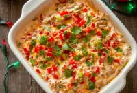 Texas-style Christmas chip and dip with creamy layers, festive colors, and bold Tex-Mex flavor—perfect for holiday parties, snacking, and vibrant Christmas appetizer spreads.