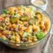 A bowl of Mac And Cheese Pasta Salad made Big Mac–style with pasta, seasoned beef, cheddar cheese, pickles, and creamy dressing—an irresistible take on Big Mac Macaroni Salad and one of the most fun Types Of Pasta Salad for parties and gatherings.