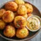 Crawfish Hush Puppies served hot and golden with a zesty Creole dip, showcasing crispy seafood bites inspired by Spicy Southern Hush Puppies and classic Dipping Sauce For Hush Puppies favorites.